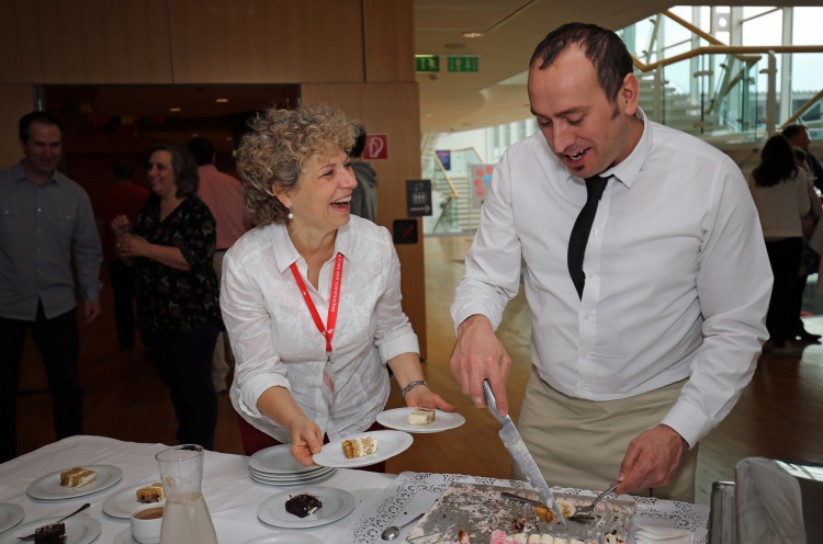 Serving delicious cake at OM EAST's 50th Anniversary celebration. Credit: OM EAST